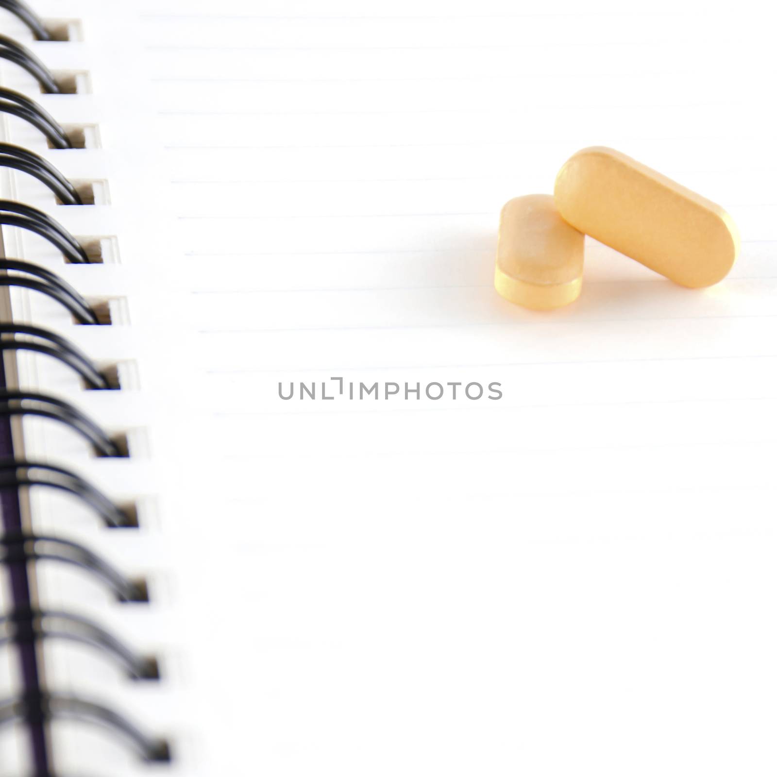 two pills on notebook by ammza12
