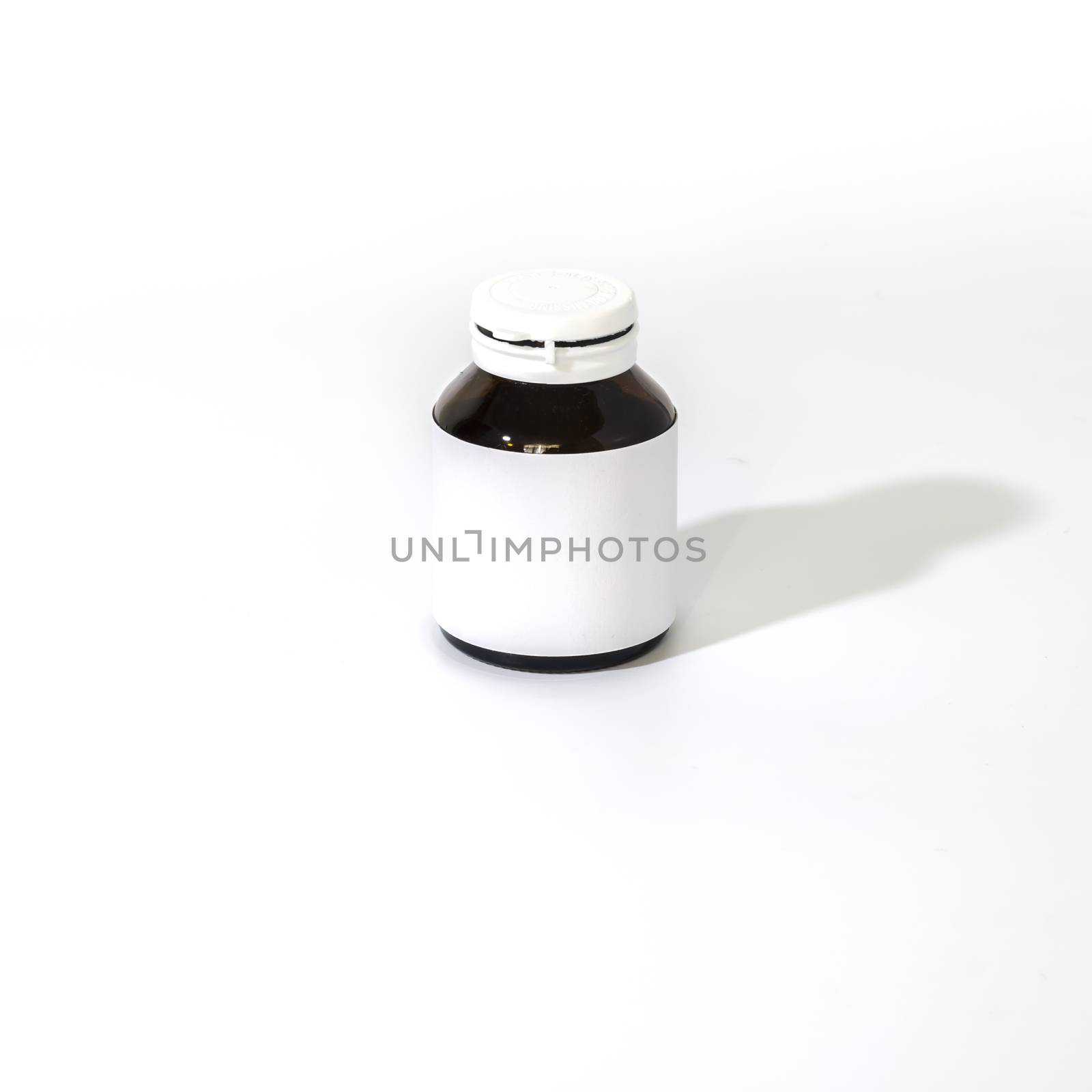 empty pill bottle on a white background