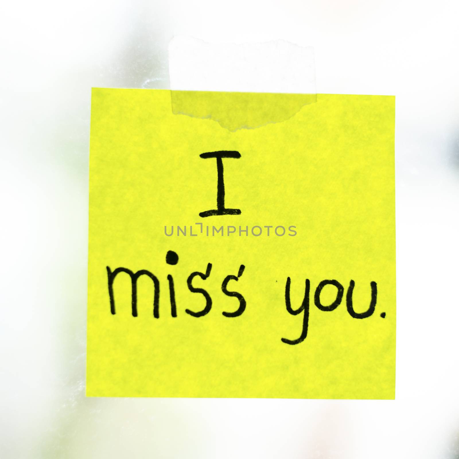 I miss you word sticky note on window mirror