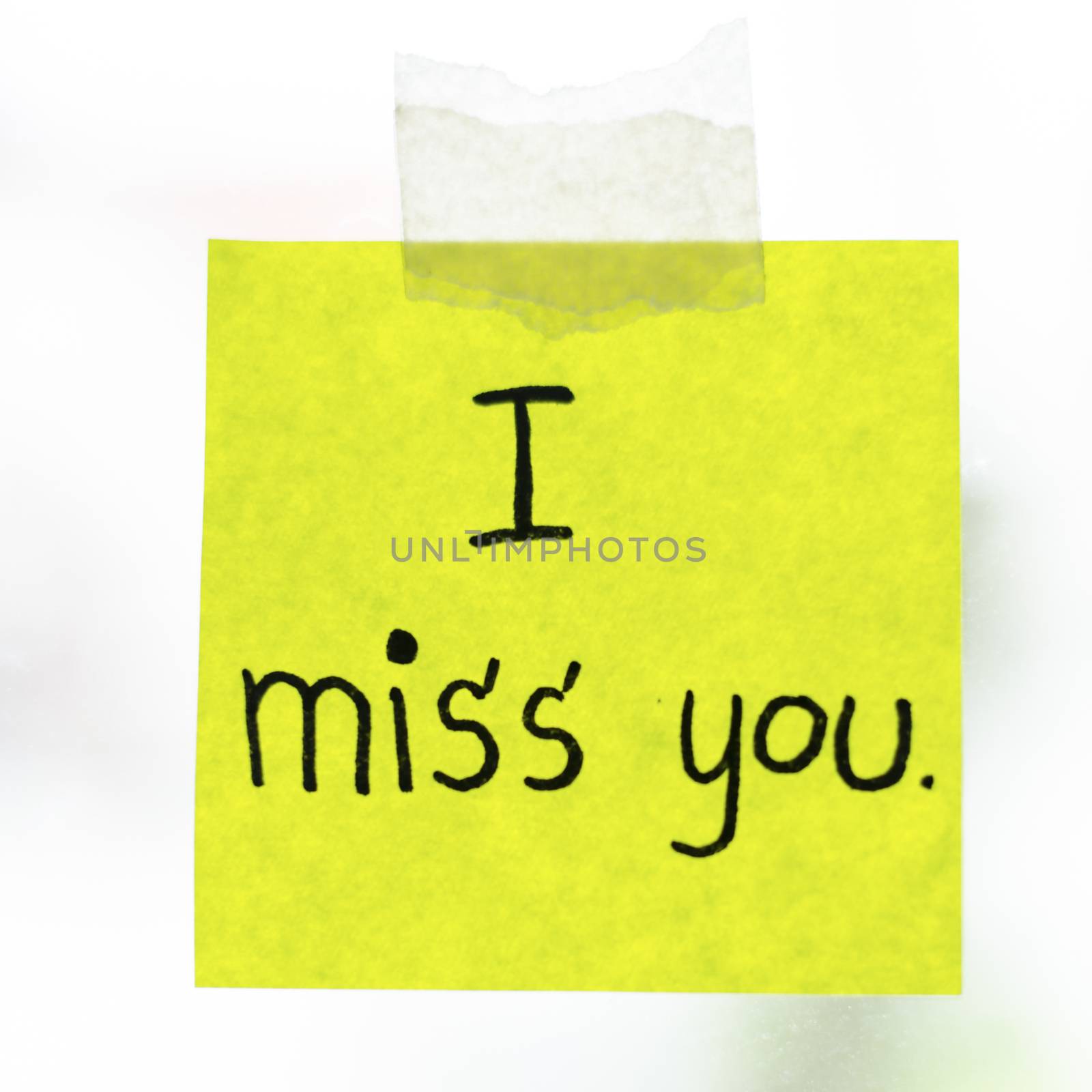 I miss you word sticky note on window mirror