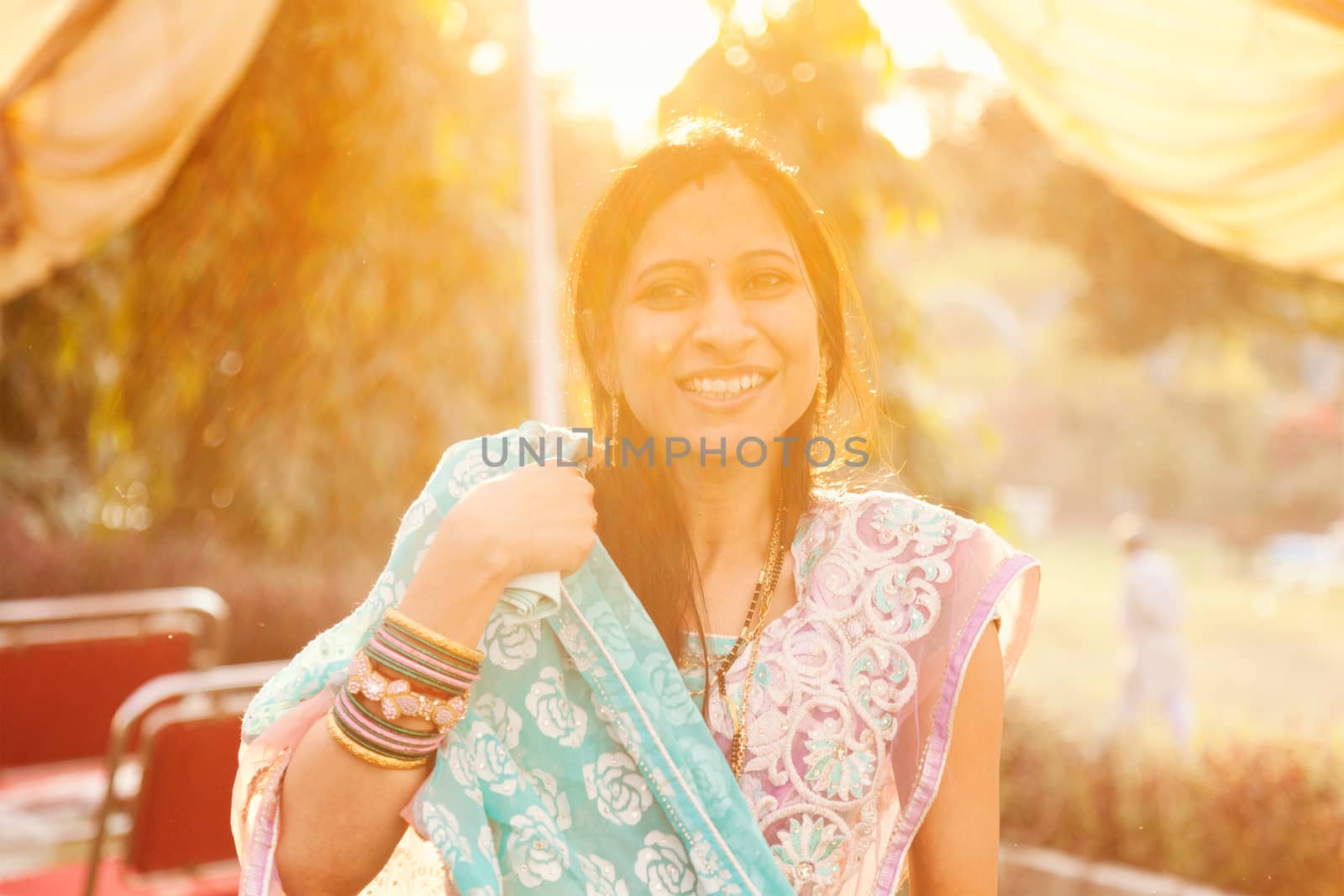 Indian women looking happy in blue and pink saree
