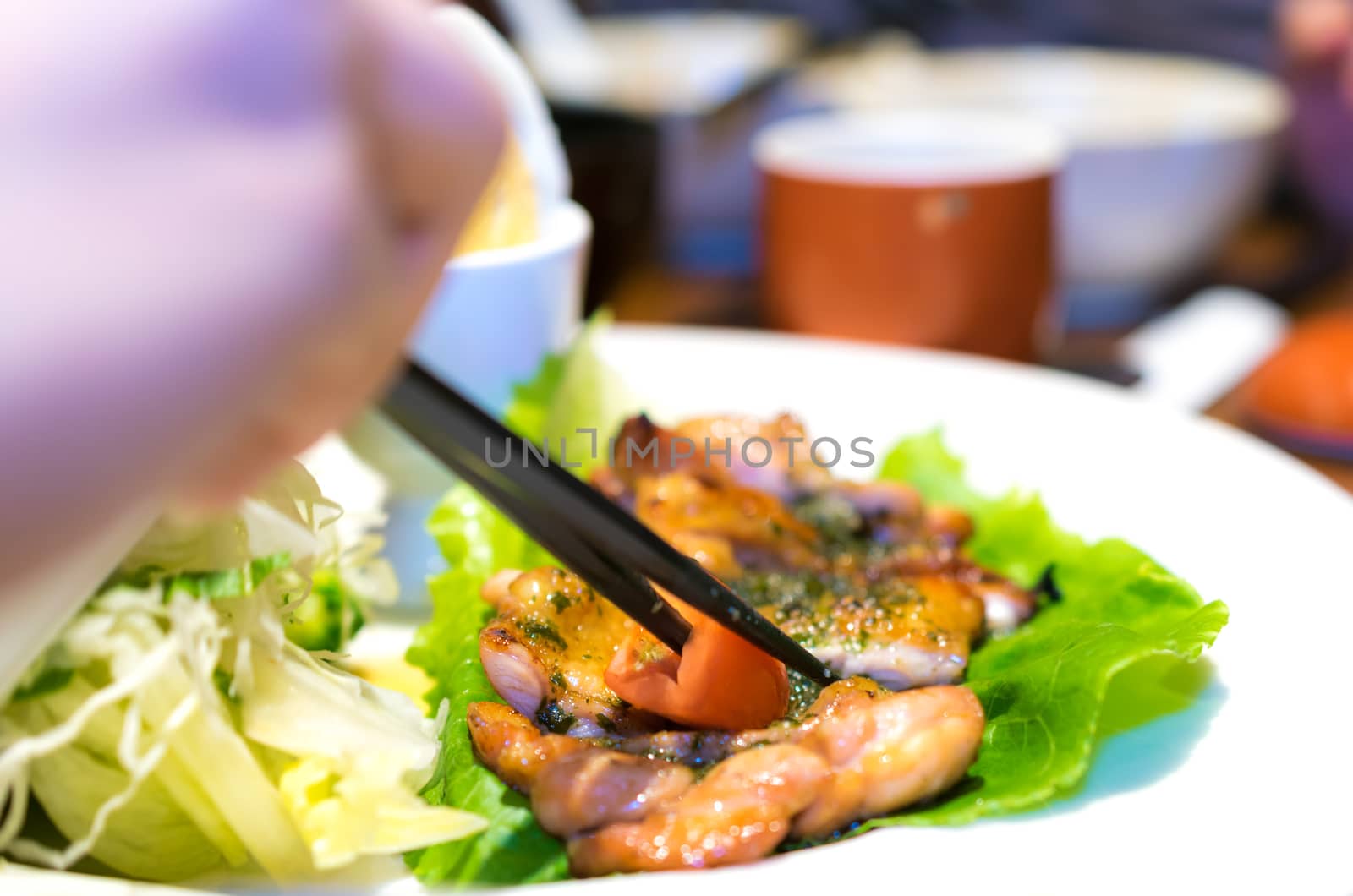 Hand Chopsticks Grilled Chicken with Egg and Salad delicious