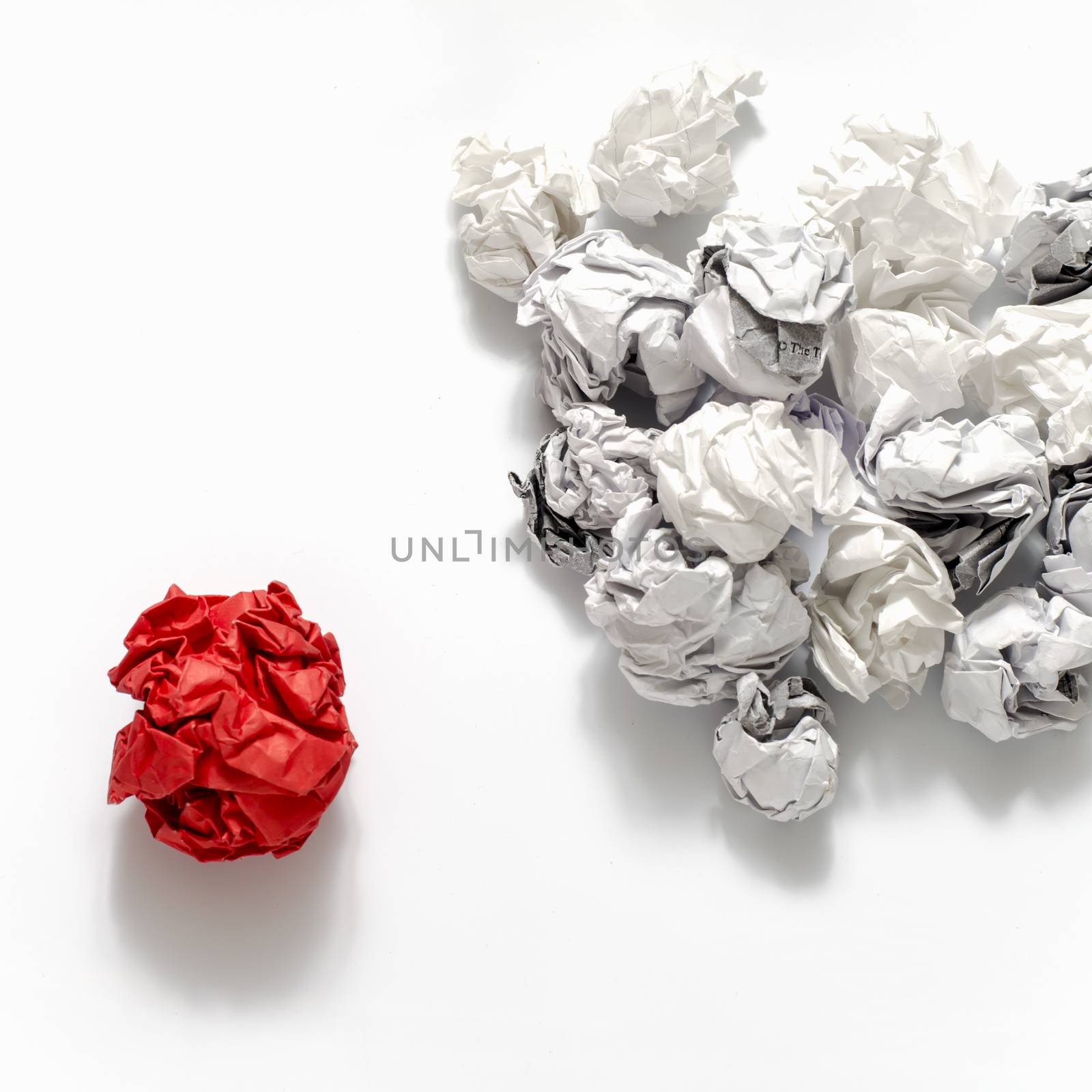white crumpled paper ball and different red crumpled paper ball on a white background