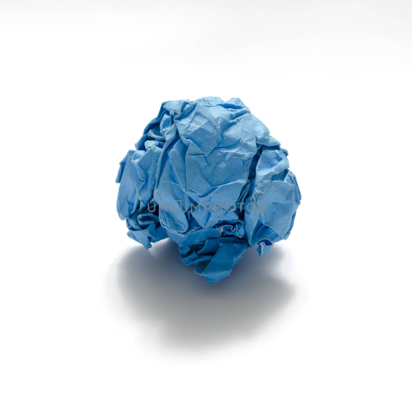 blue color crumpled paper ball on a white background