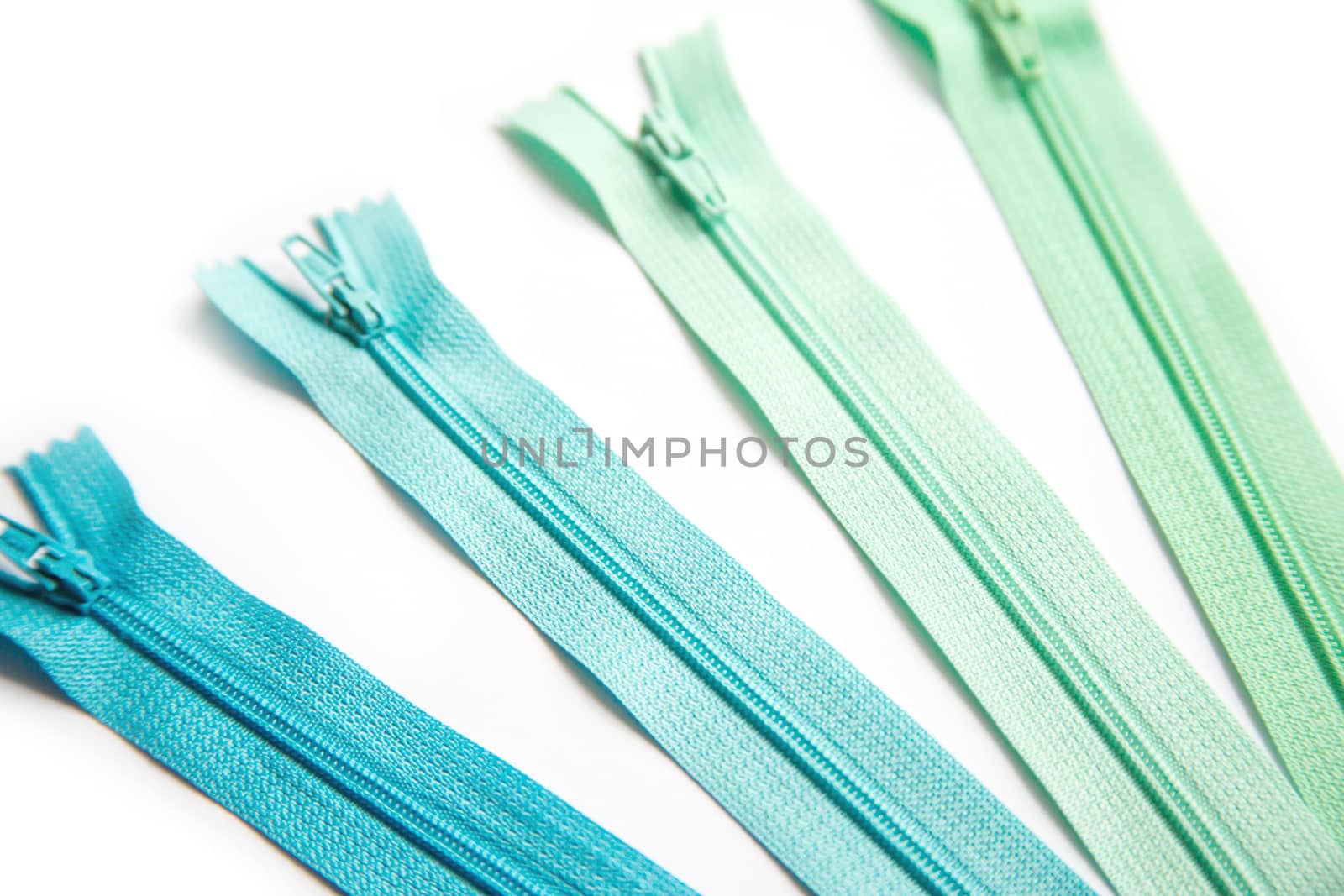 Green and blue clothing zipper set isolated on white background