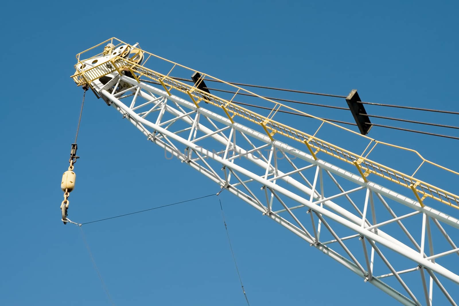 dockyard cargo crane detail against a blue sky