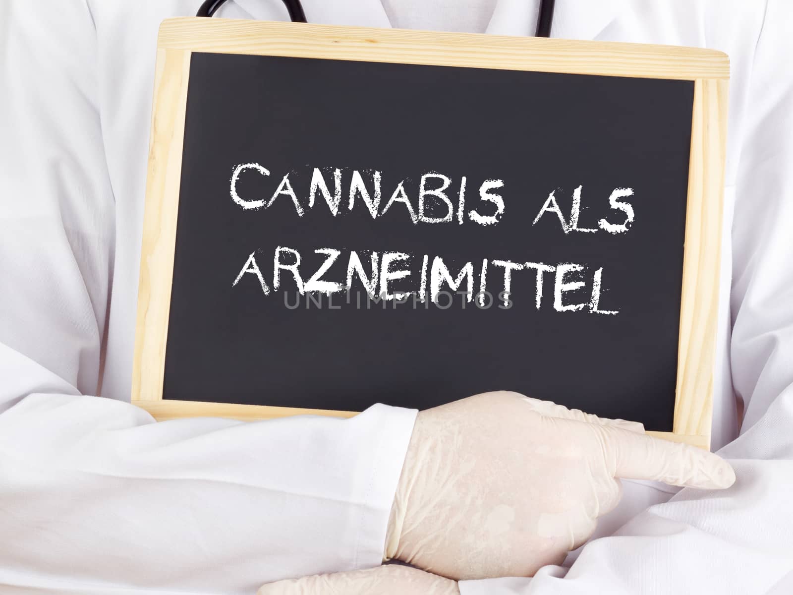 Doctor shows information on blackboard: medical cannabis in german by gwolters