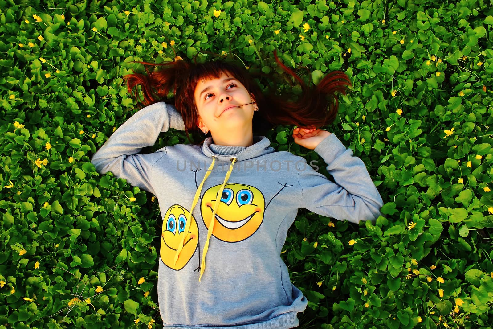 happy girl lying on the grass by scherbinator