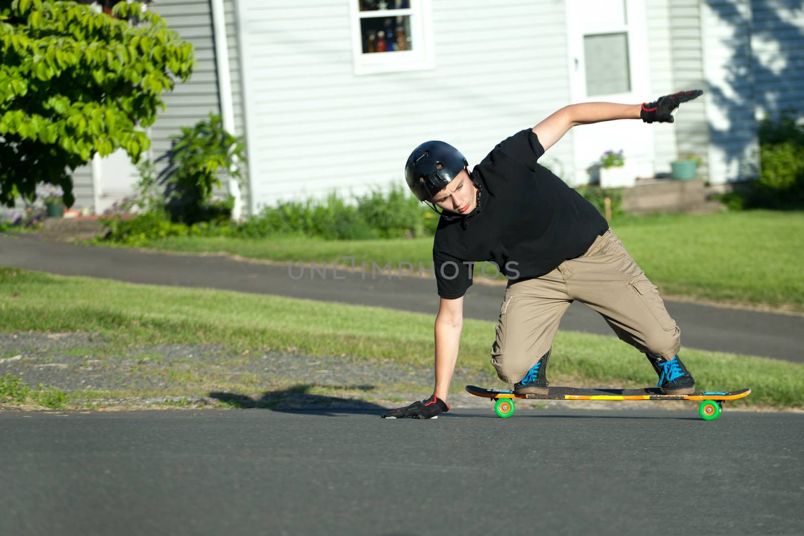 Action shot of a longboarder skating on the street. 
