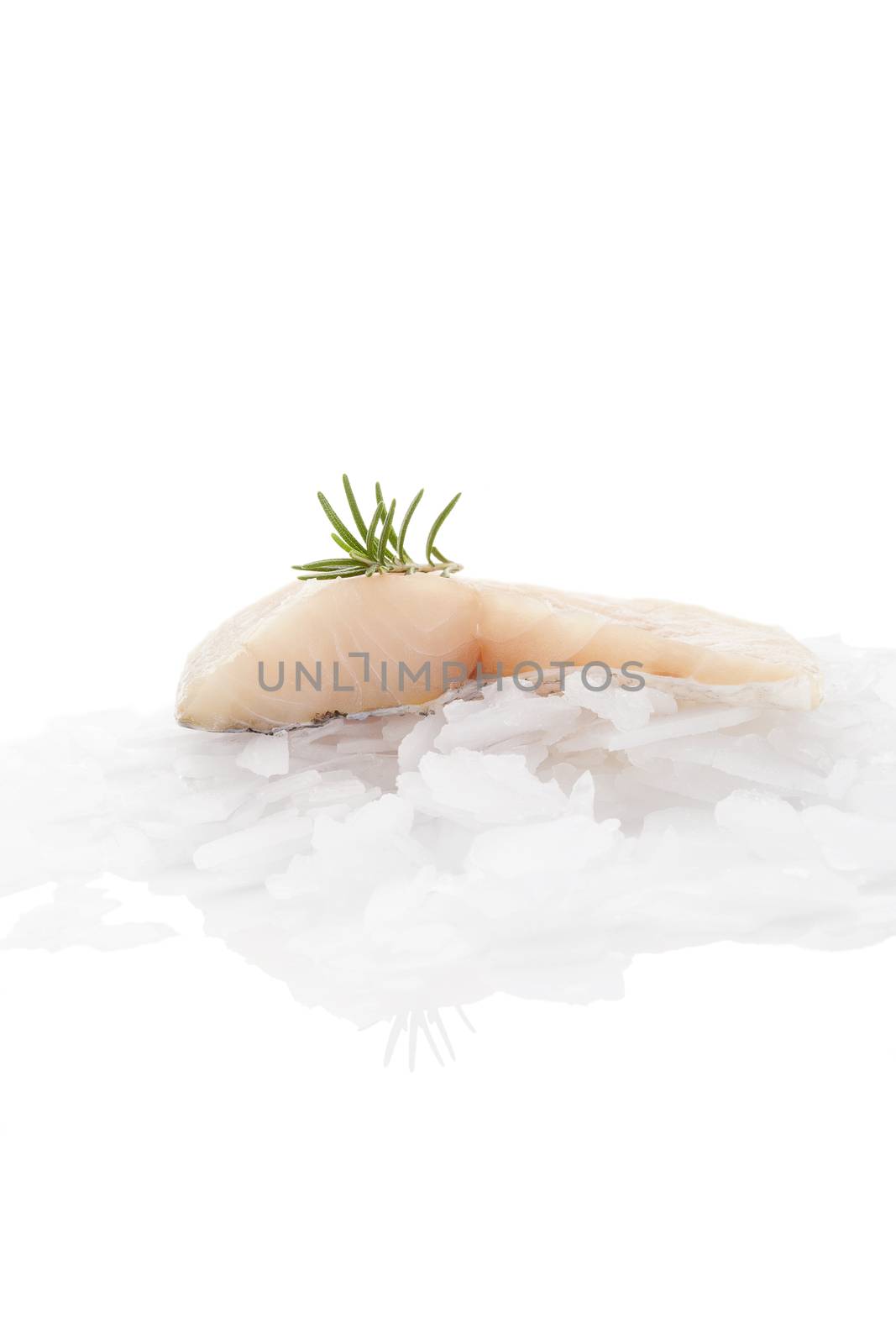 Fish fillet on ice isolated on white background. by eskymaks
