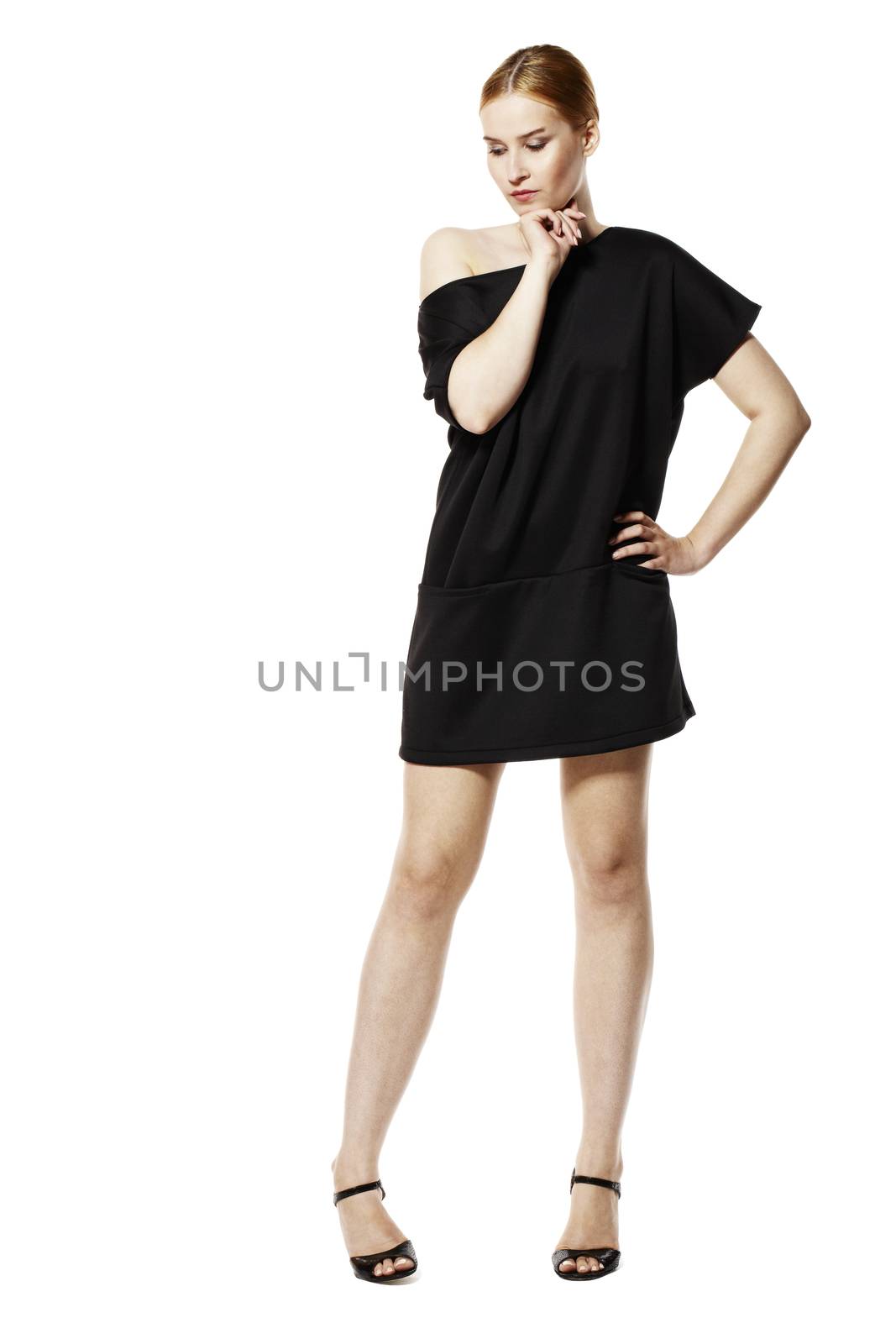 Studio shot of attractive young woman in black tunic.  