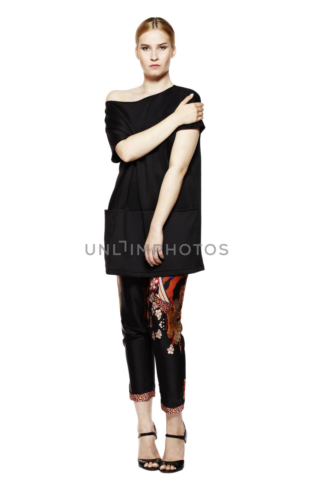 Studio shot of attractive young woman in black tunic.  