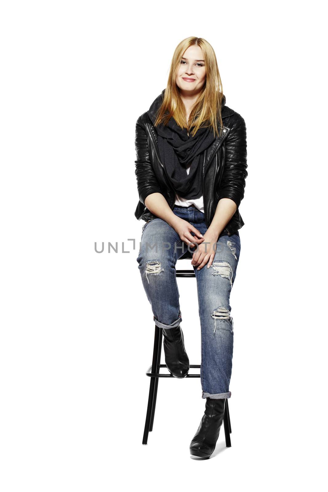 Young blonde woman sitting on high stool. Isolated on white background.