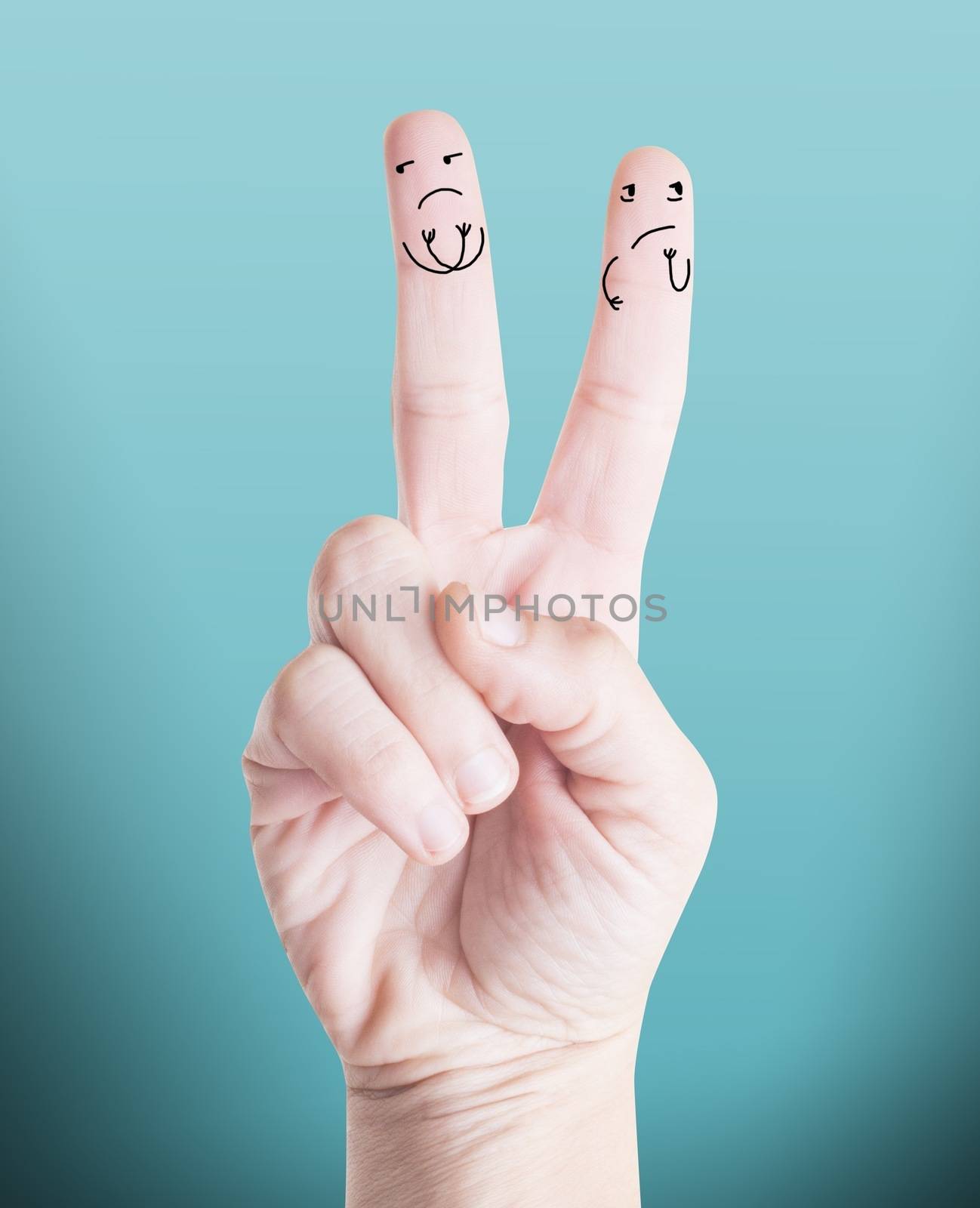 Close up picture of a male hand with angry characters drawn on fingers