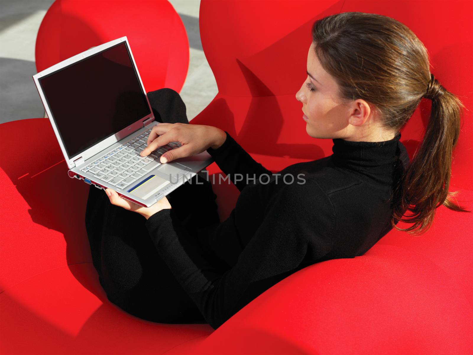 woman using laptop at home a by toocan