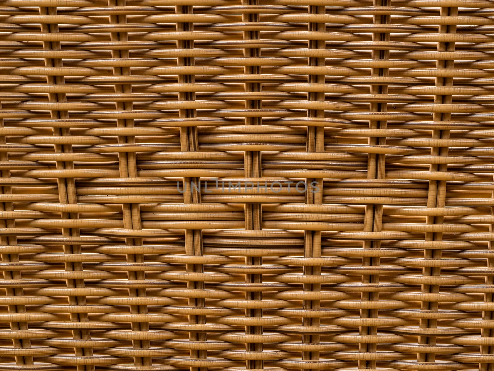 Closeup shot of a pattern on the back of a reed thatch chair
