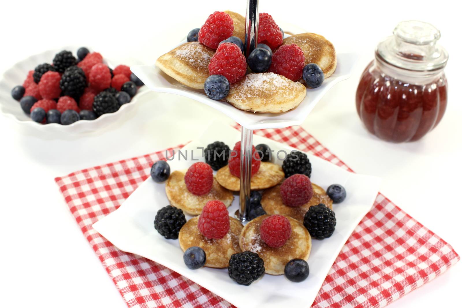 Poffertjes with berries on a cake stand by discovery