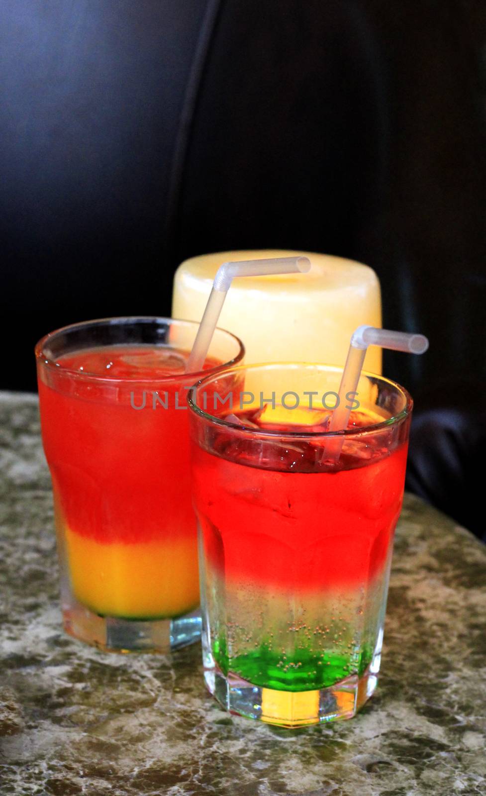 Glass of drink with a straw on the marble table