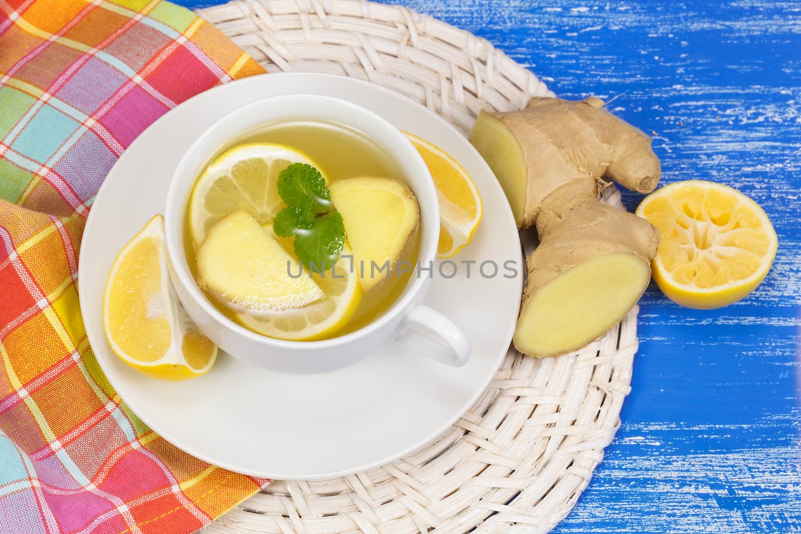 Ginger in a cup of tea with lemon and mint. Macro, selective focus