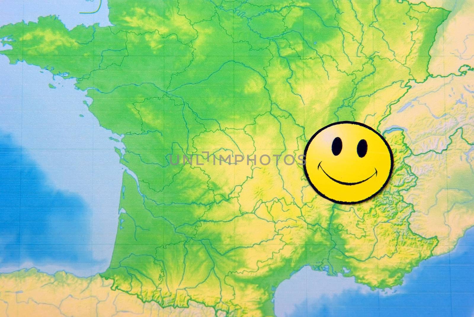 Yellow happy face on France map, close up image.