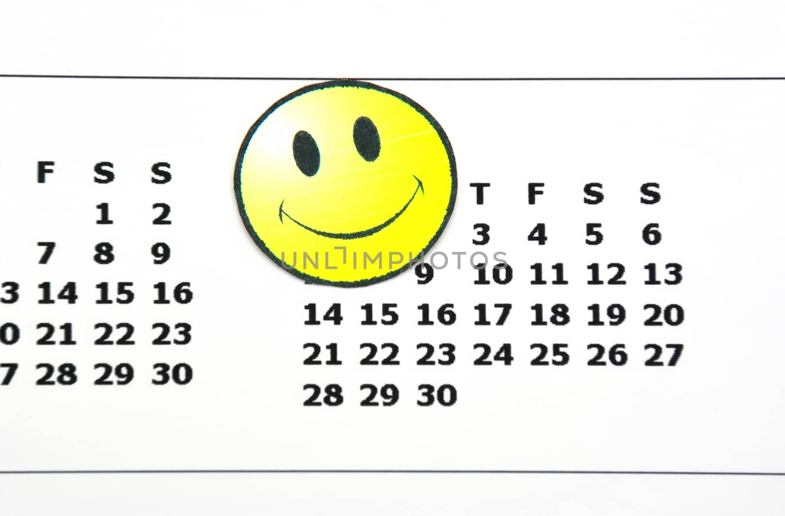 Happy face on a calendar, close image.