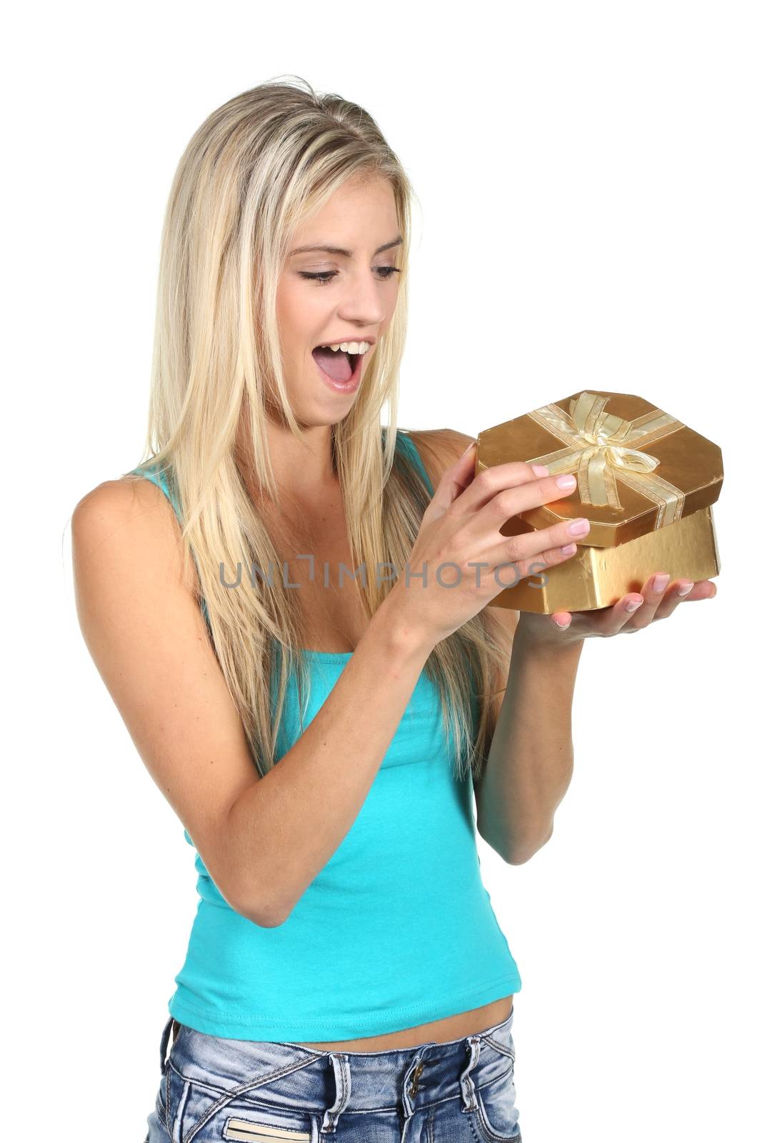 Lovely young blond lady with excited look opening a present