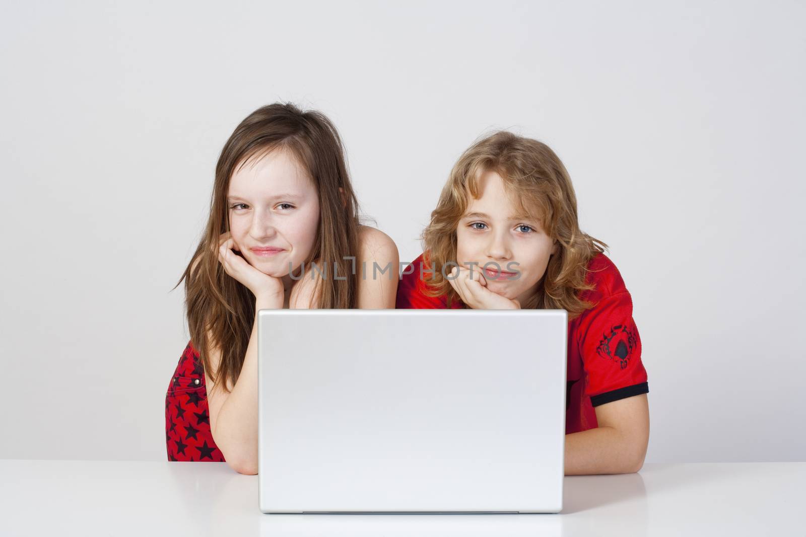 young boy and girl having fun with laptop computer