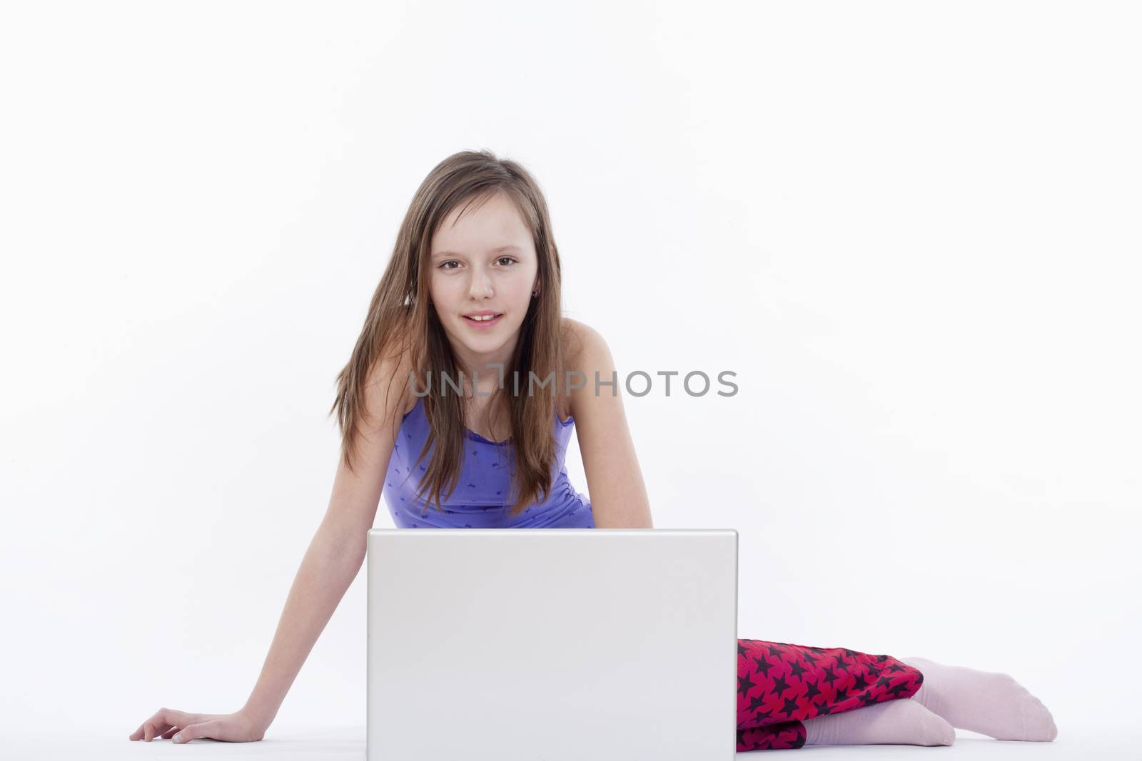 young girl sitting with laptop computer - isolated on white