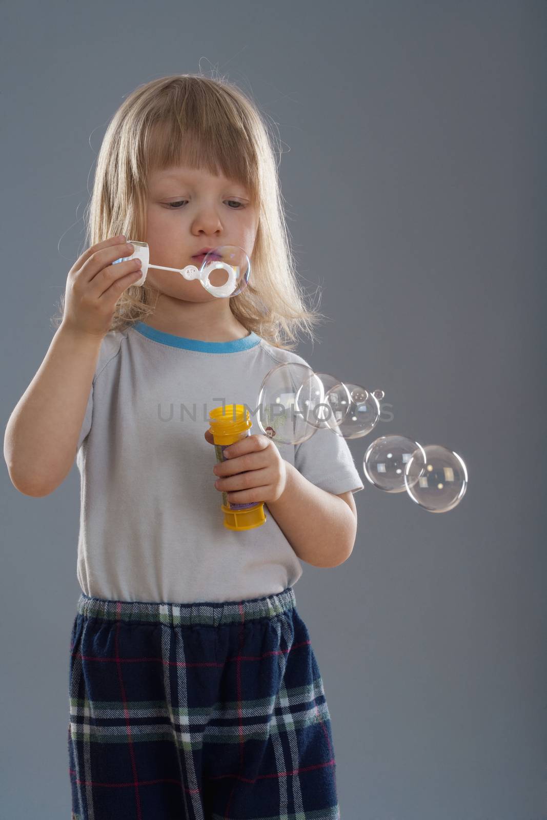 boy blowing bubbles by courtyardpix