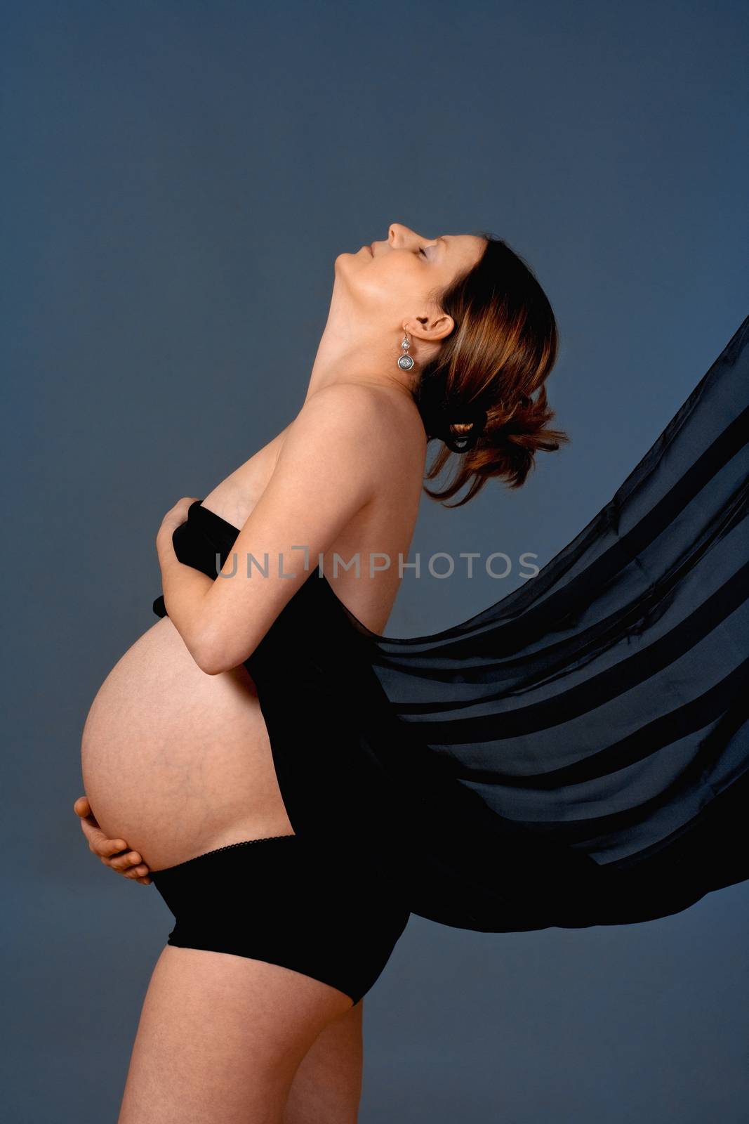 expecting woman - studio shot of a pregnant woman with cloth