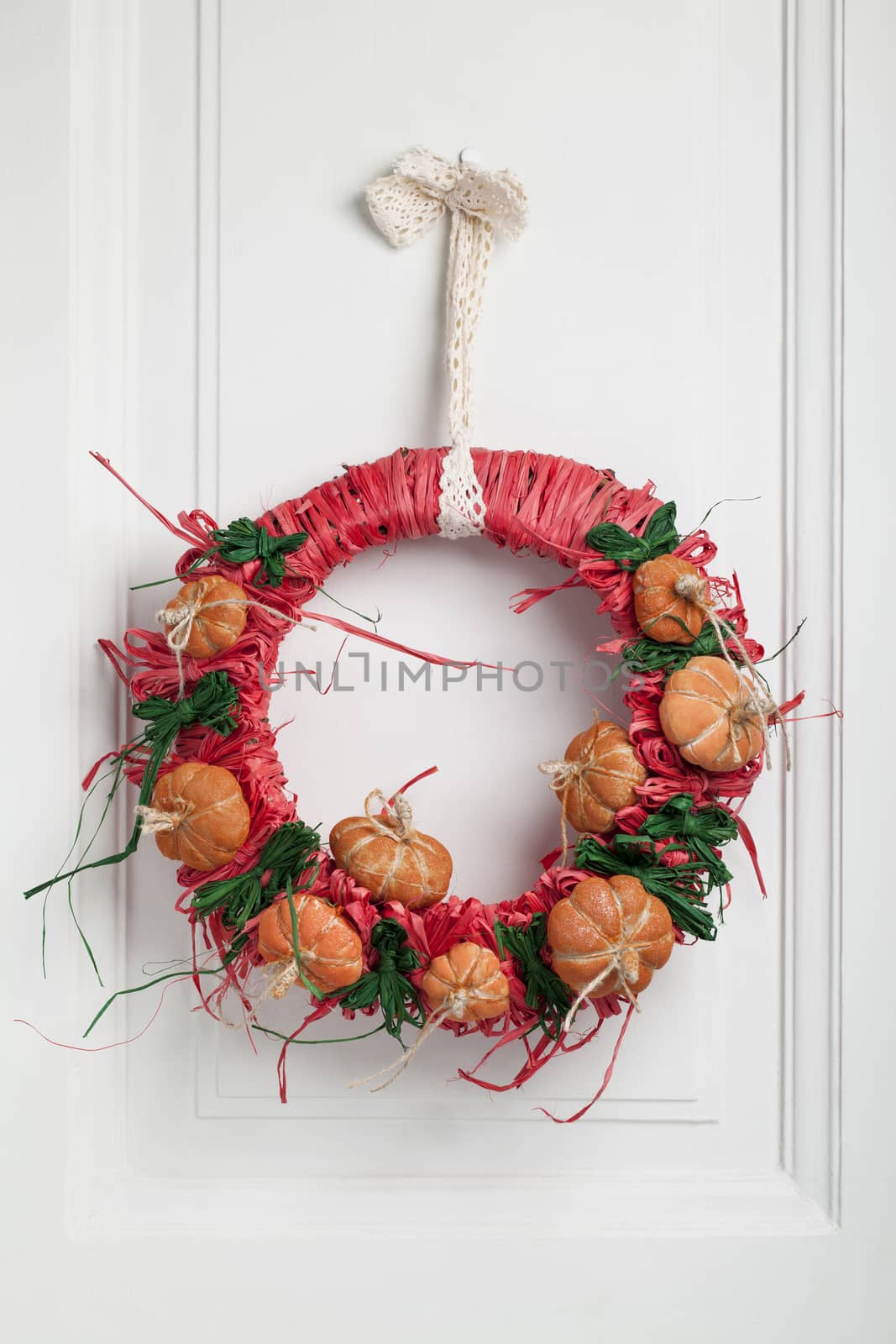 Decorated halloween twig wreath with little pumpkins