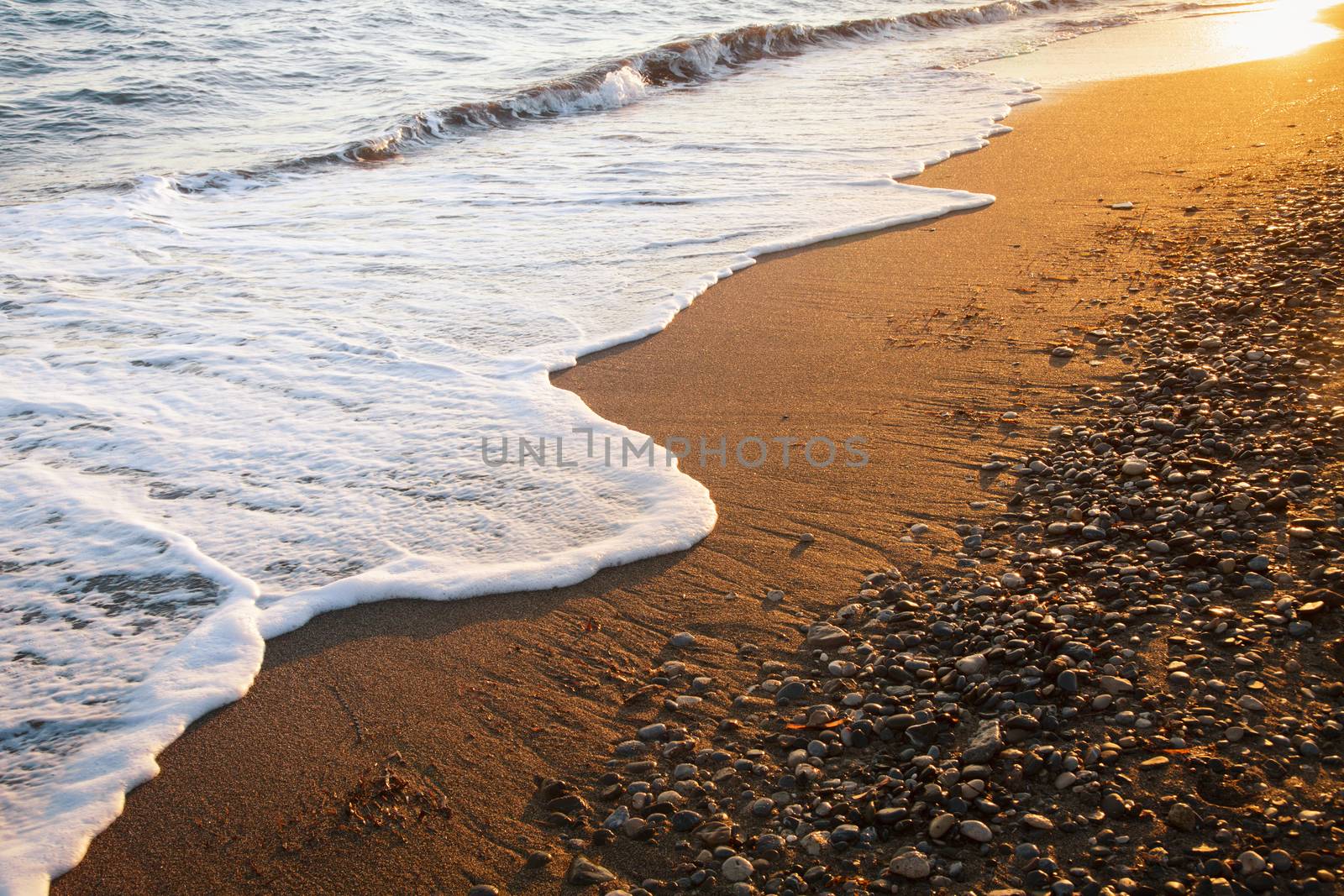 Wave on a beach at dawn by naumoid
