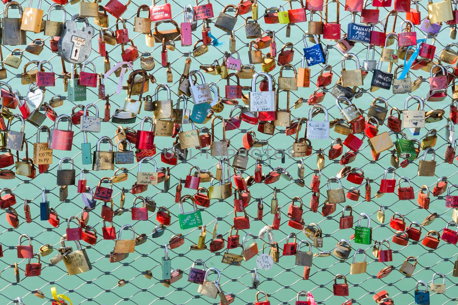 Newlyweds and lovers hang padlocks on the bridge over the river as a sign of love and fidelity