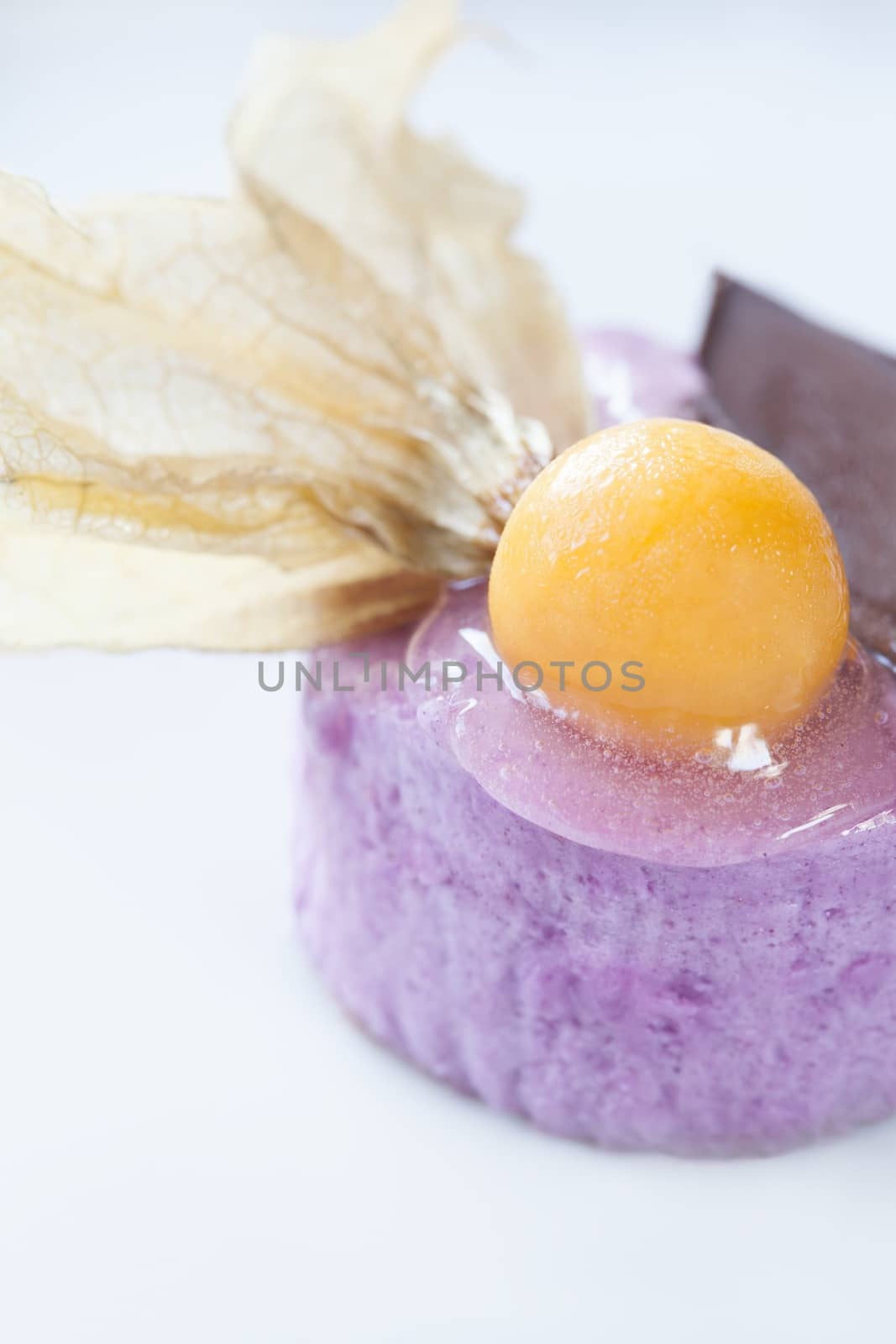 Close-up picture of a dessert with chocolate and fruit decoration