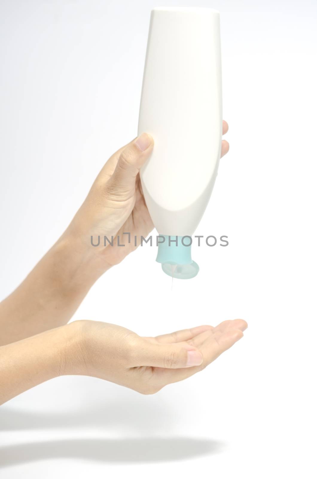 woman pouring body lotion on hand isolated on white background