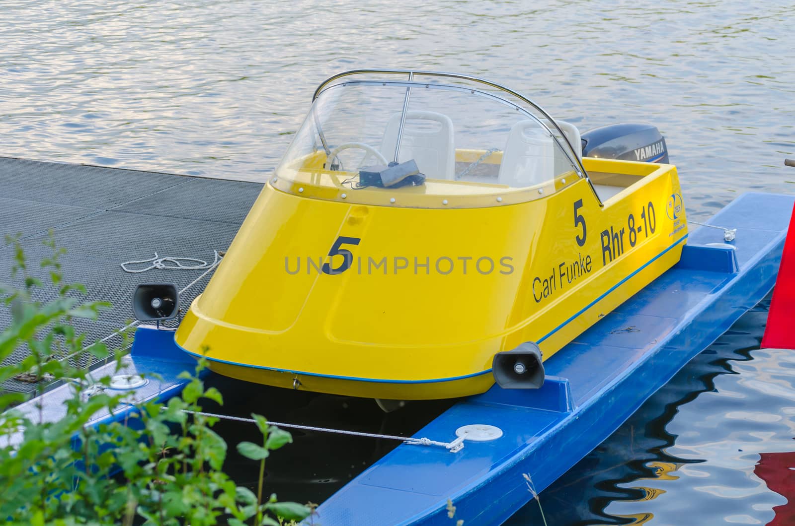 Essen, Germany - June 21.2014: Support vessel from which the coach gives instructions during rowing rowing training. At the jetty in Essen on Baldeneysee height Regatta tower.