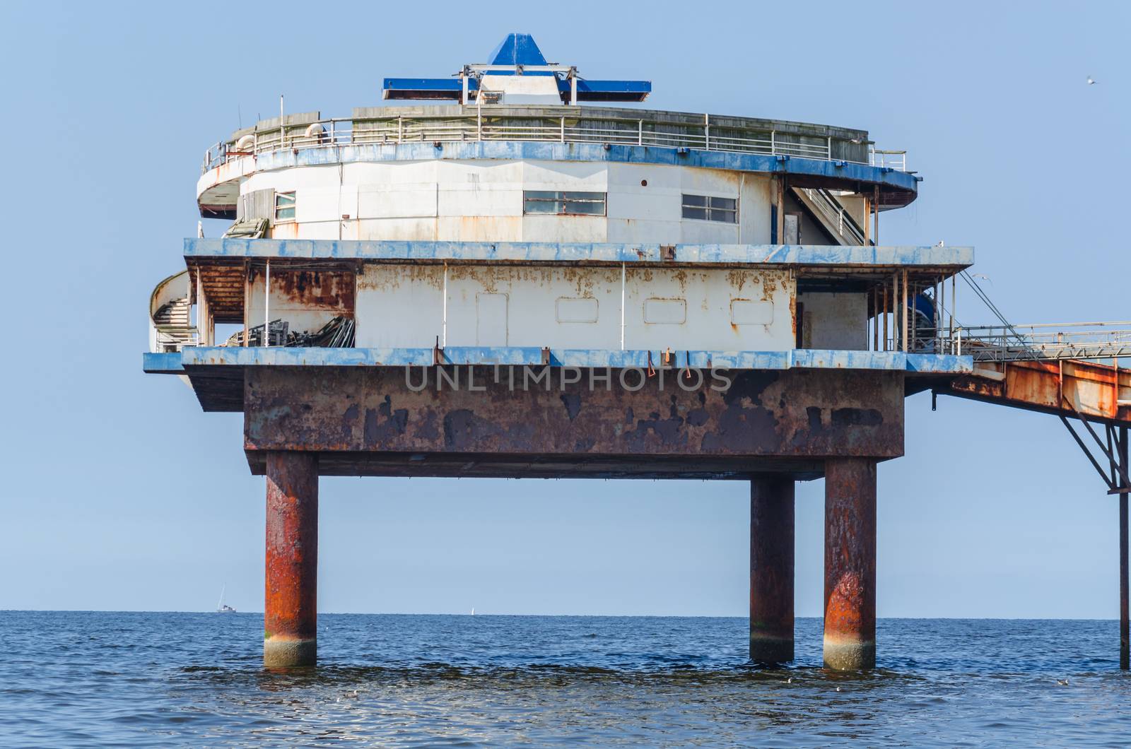 View from the beach on the currently locked old jetty, landing stage, Pier of Scheveningen in the Nederlanden.