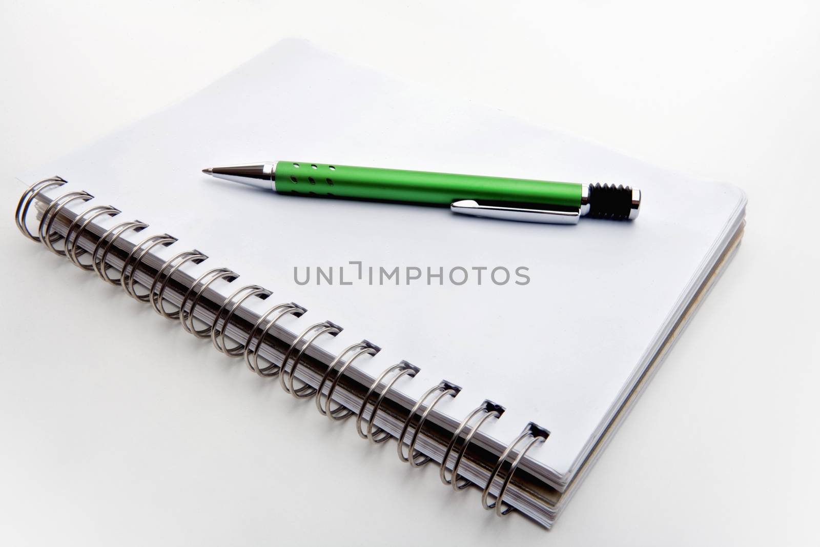 ballpoint pen and spiral notebook isolated on white