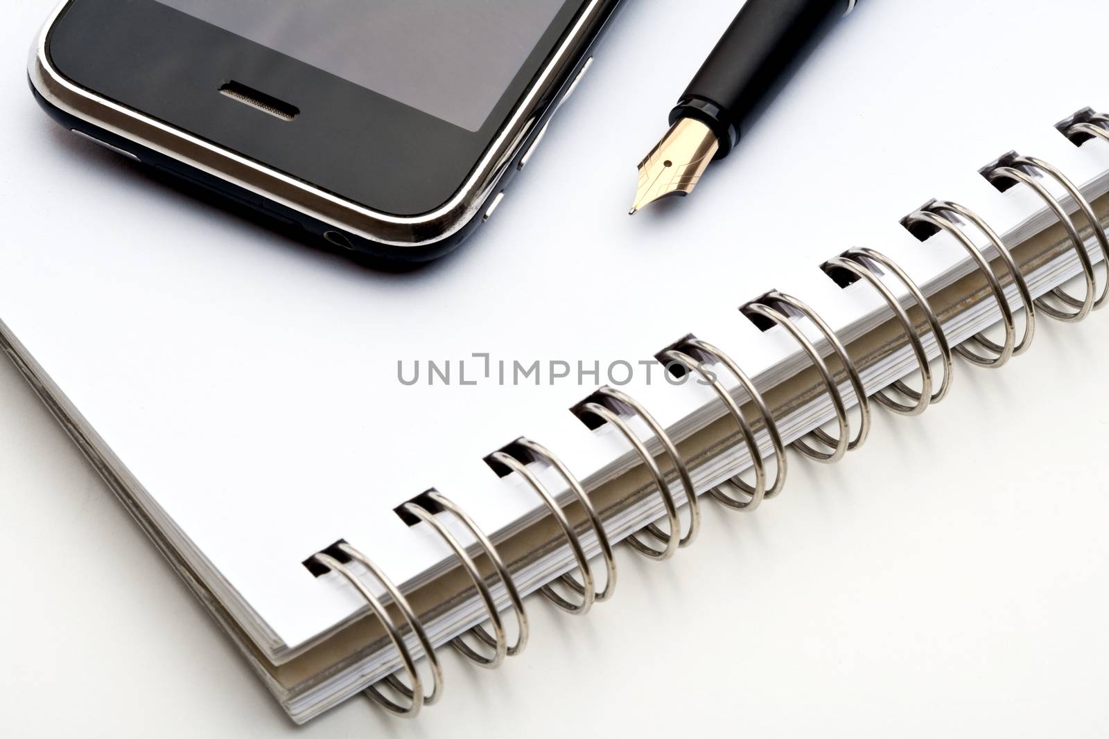 pen, notebook and cell phone by courtyardpix