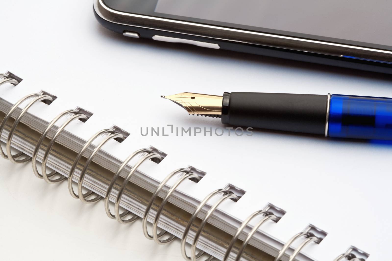 pen, notebook and cell phone by courtyardpix