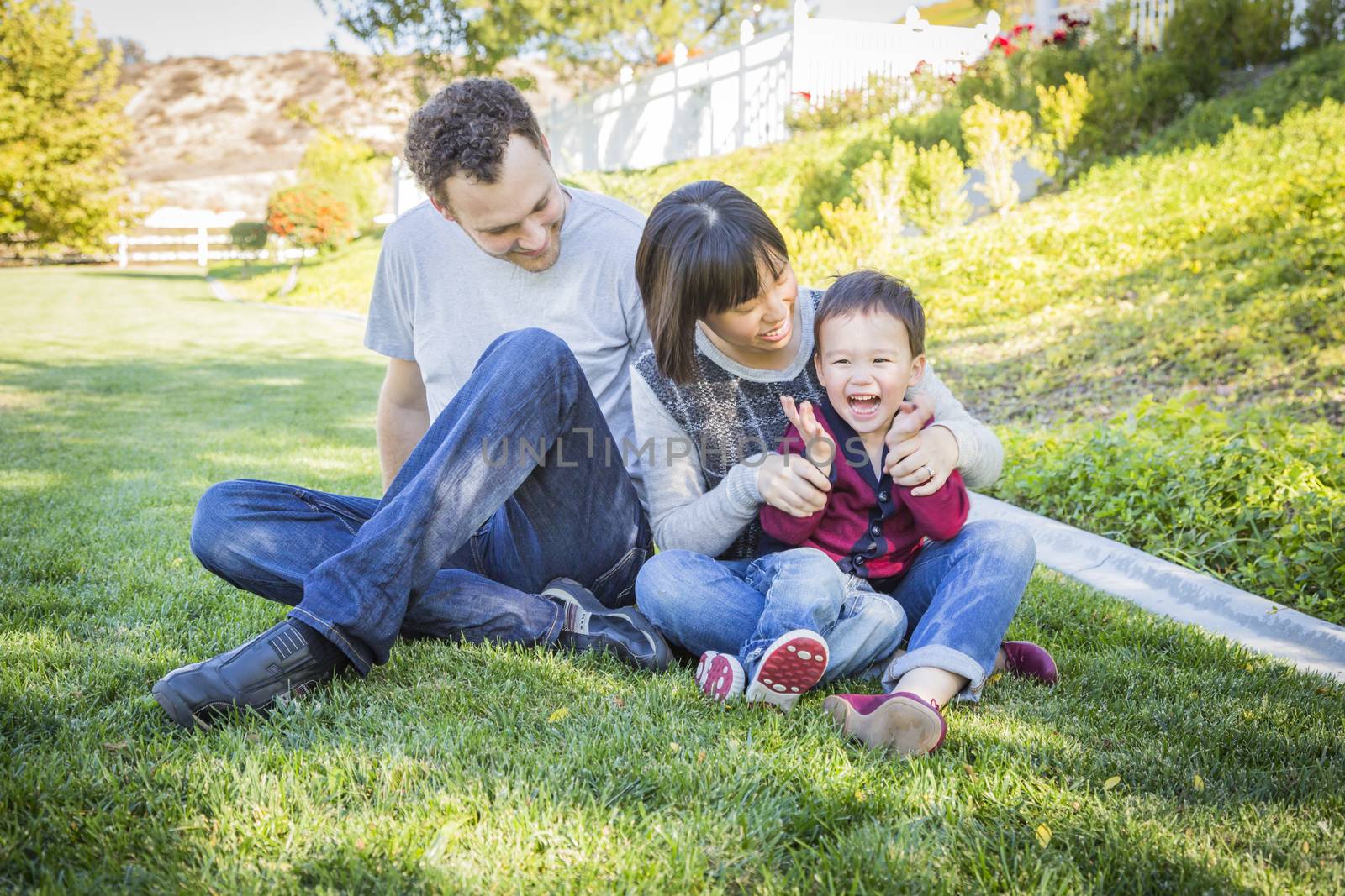 Mixed Race Family Having Fun Outside by Feverpitched