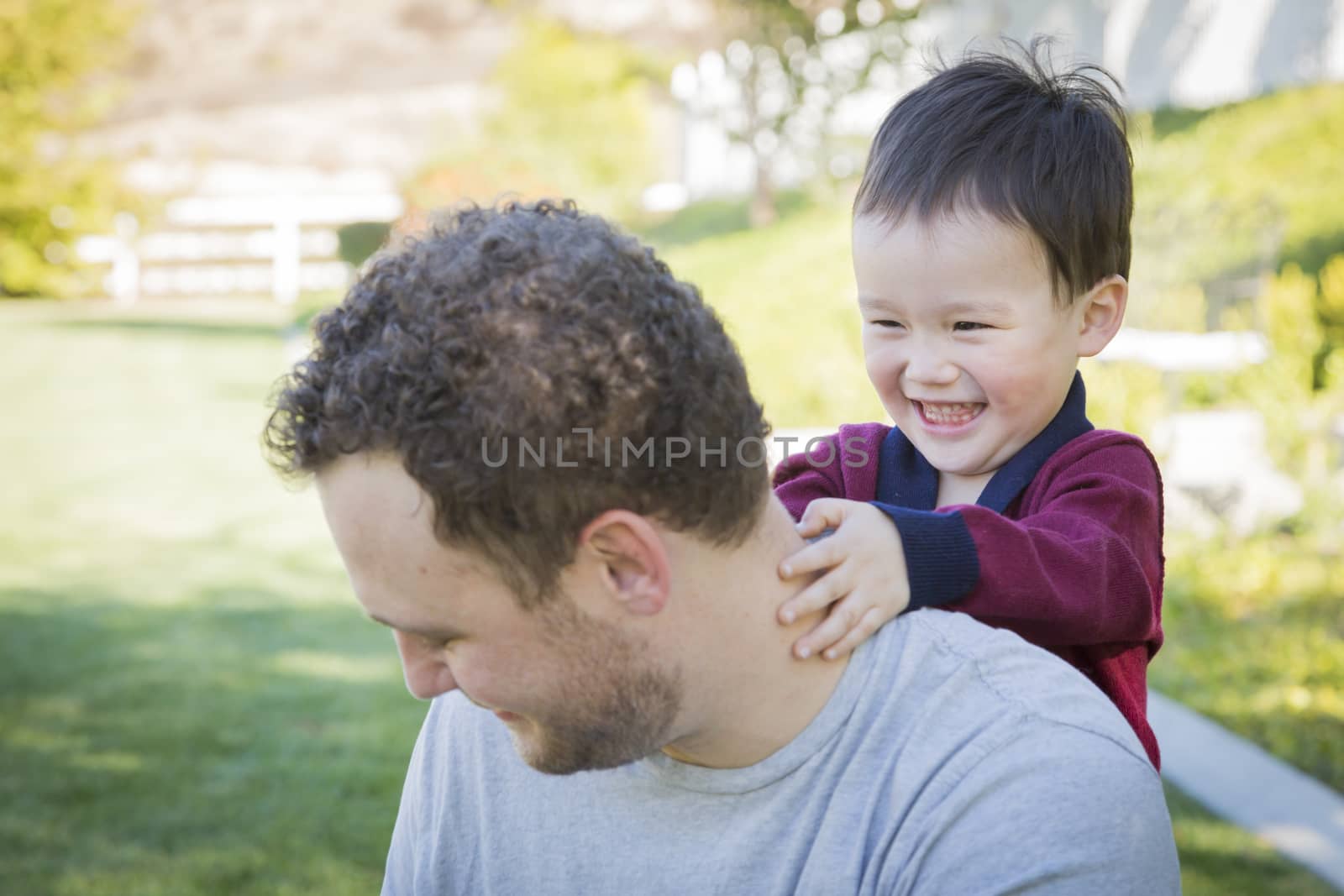 Happy Caucasian Father Having Fun with His Mixed Race Baby Son.