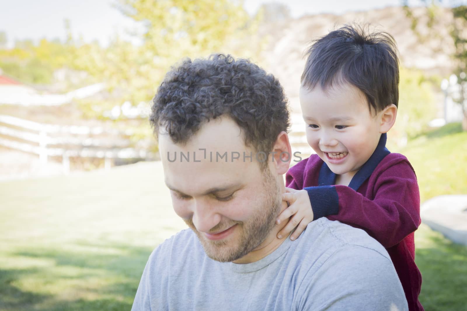 Happy Caucasian Father Having Fun with His Mixed Race Baby Son.