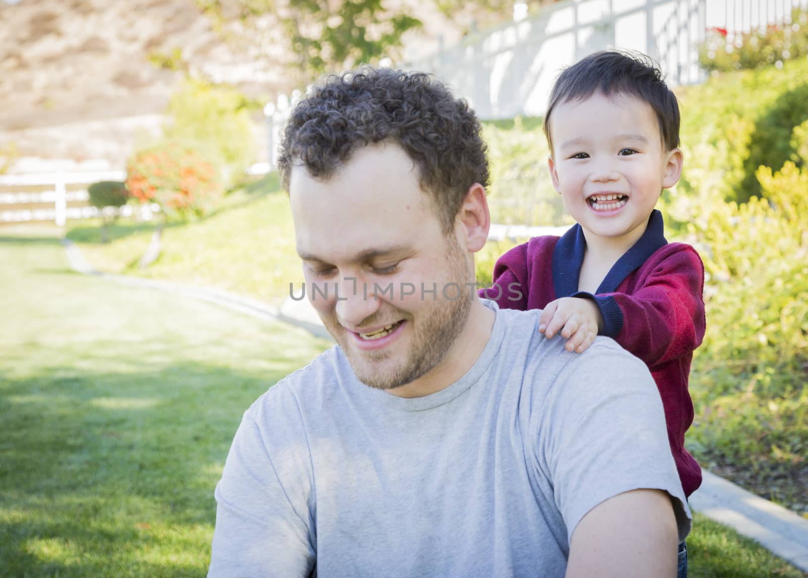 Happy Caucasian Father Having Fun with His Mixed Race Baby Son.