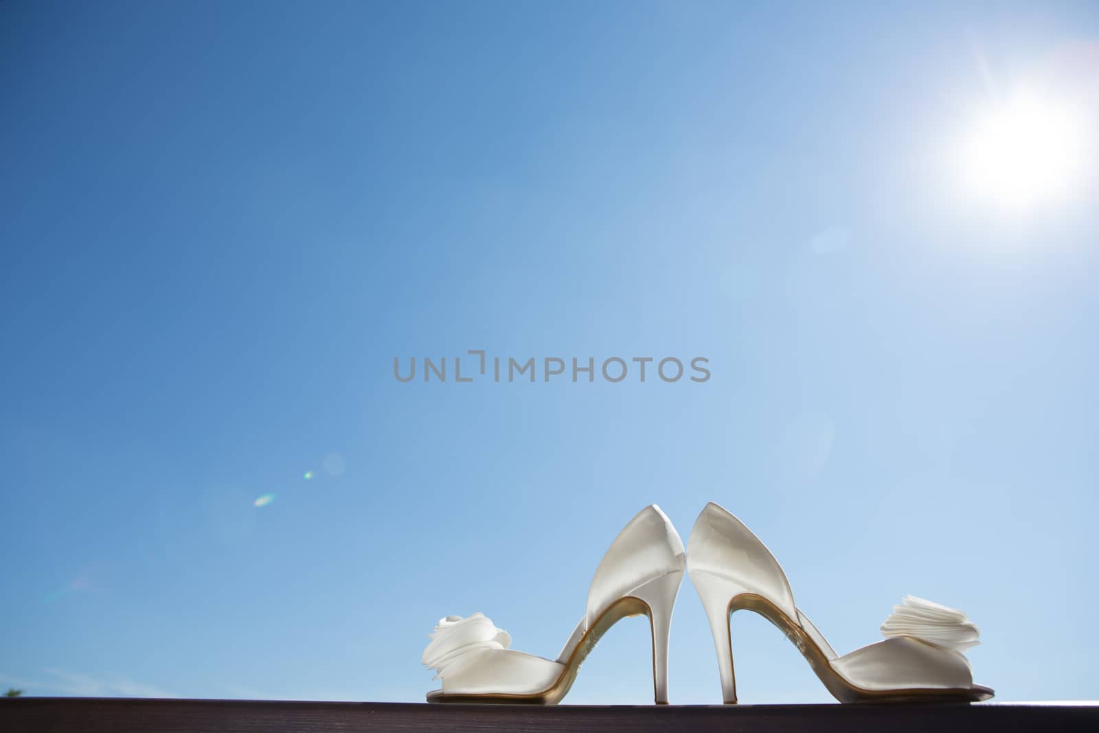 white wedding shoes with a bow . Close up