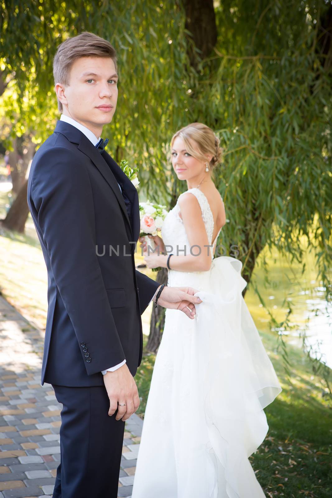 Beautiful wedding couple is enjoying wedding in the sun. 