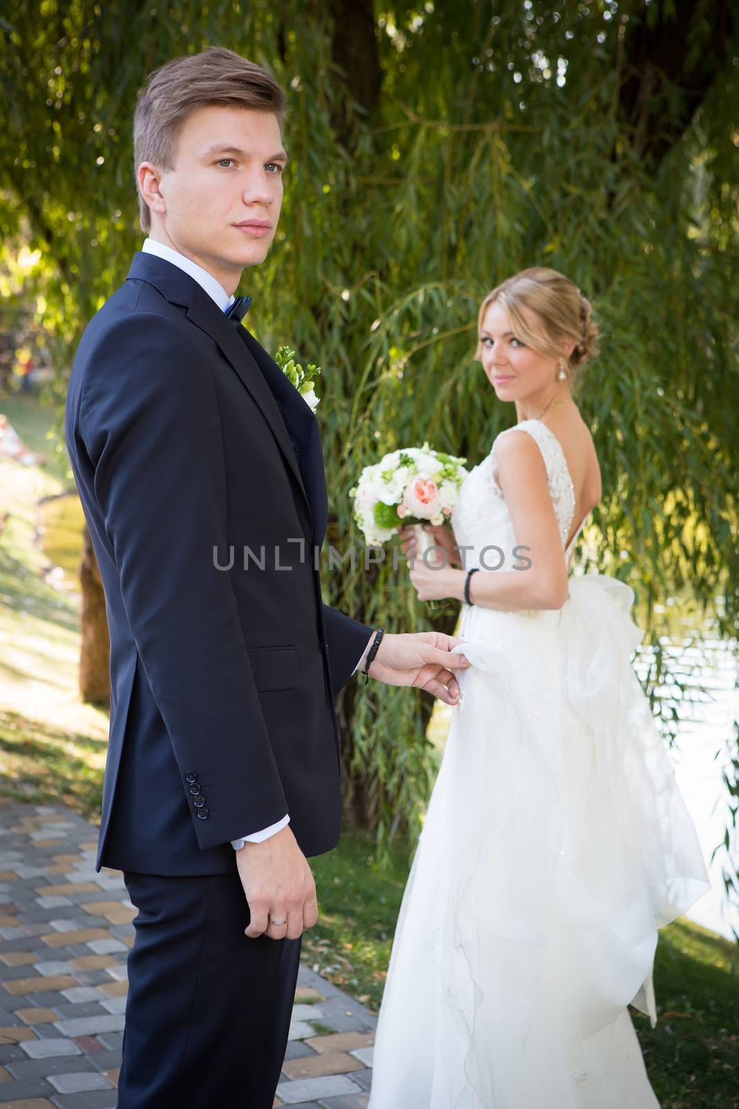 Beautiful wedding couple is enjoying wedding in the sun. 