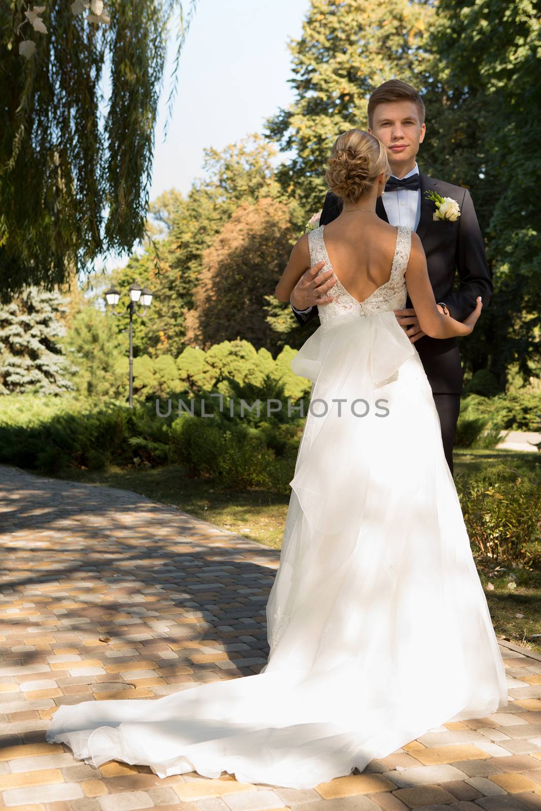 Beautiful wedding couple is enjoying wedding in the sun. 