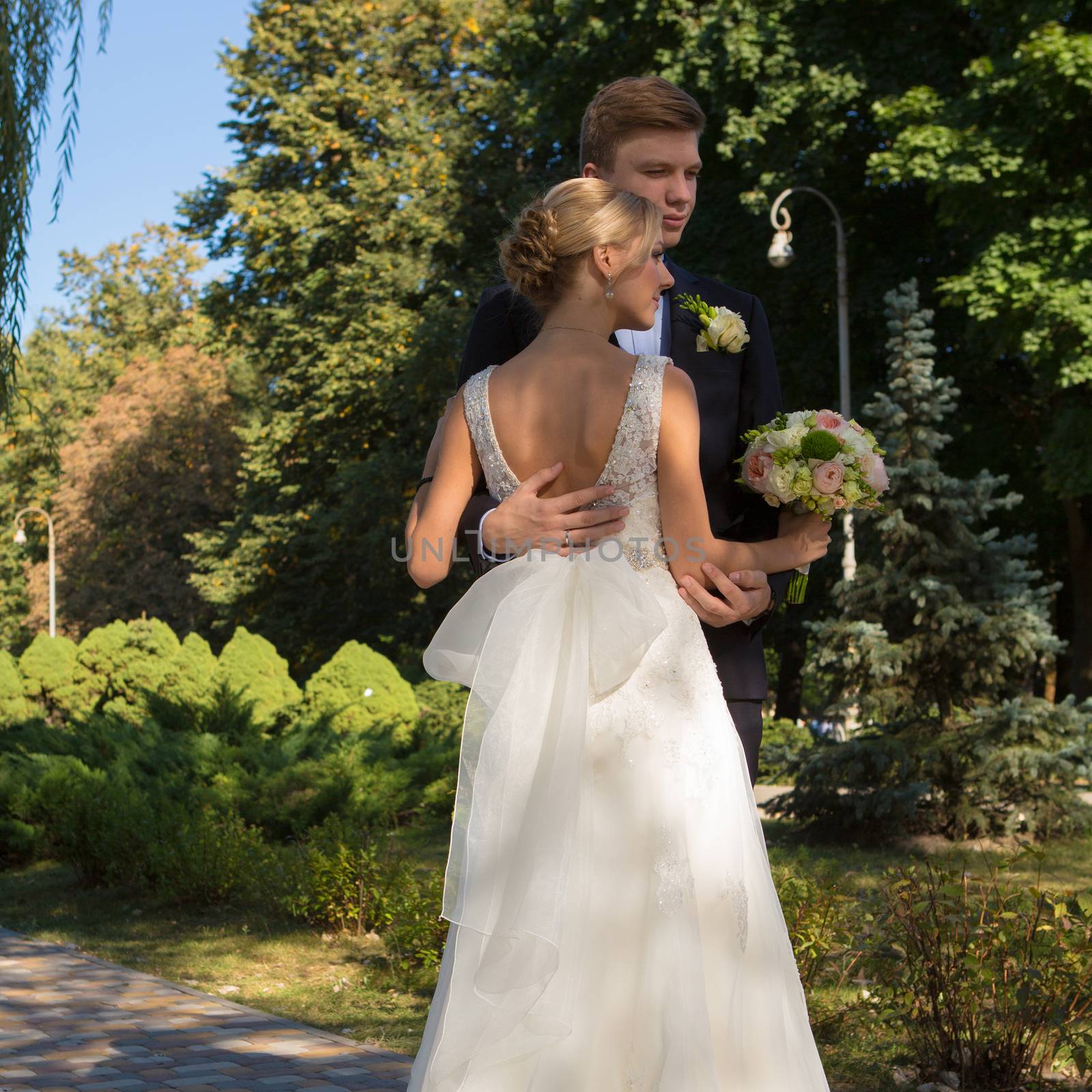 Beautiful wedding couple is enjoying wedding in the sun. 