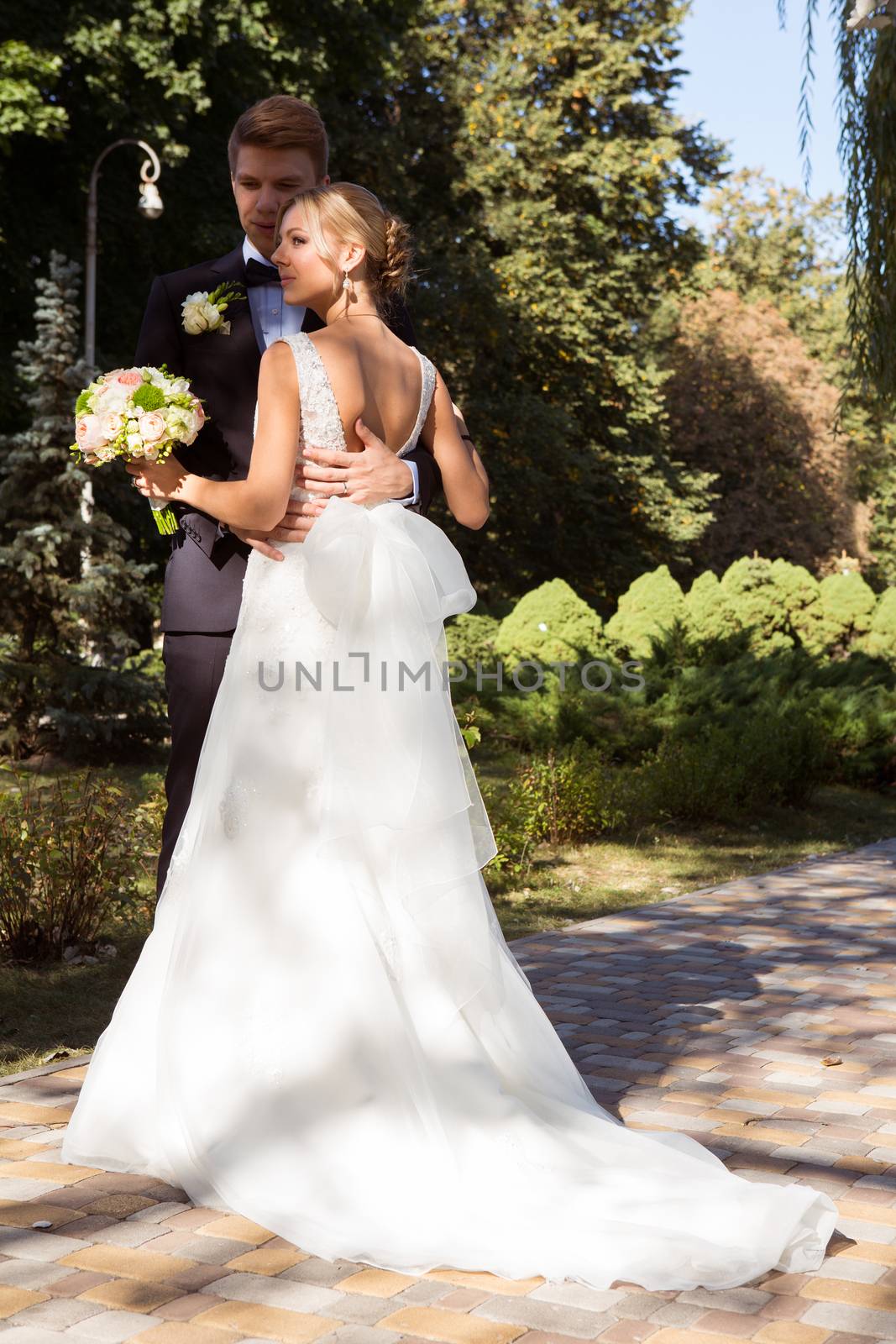 Beautiful wedding couple is enjoying wedding in the sun. 